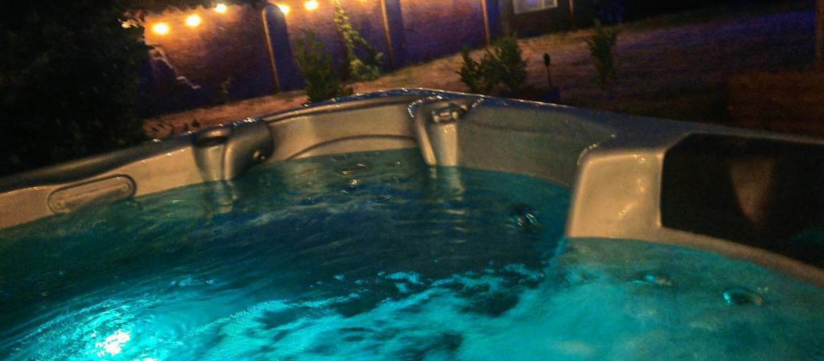 Outdoor hot tub with festoon lighting